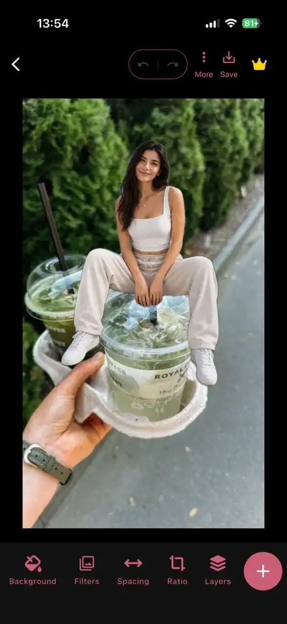 The editor in CollagePhotoApp with a 3D collage on a Story canvas and Background, Filters, Spacing, Ratio and Layers controls with girl cutout done using humanout feature sitting on top of a cup on canvas